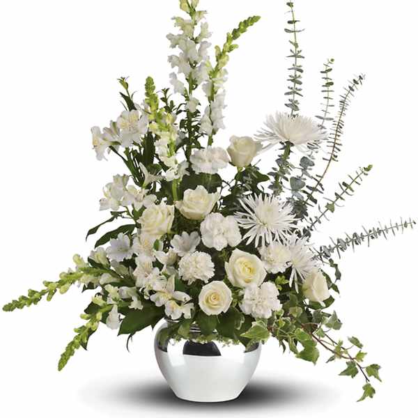White floral arrangement in a silver vase with tall stems
