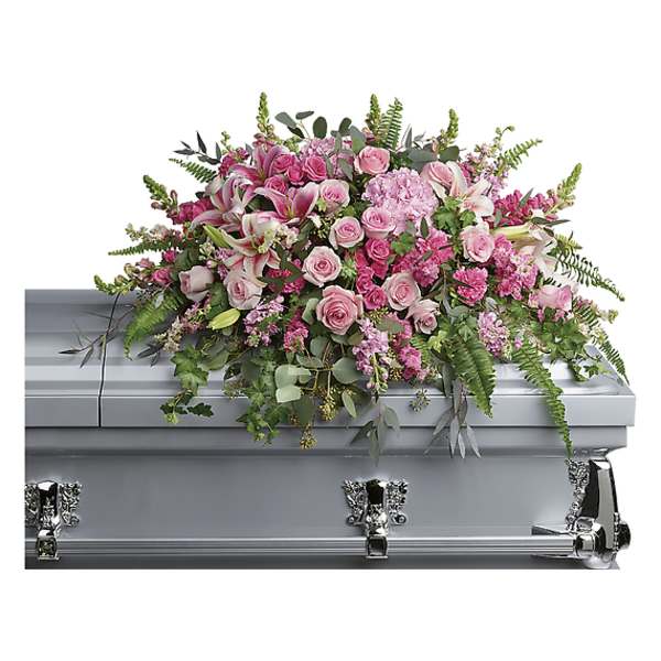 Pink floral spray on a silver casket