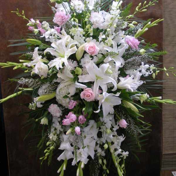 Large white and pink floral standing spray with lilies and roses