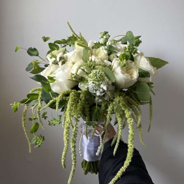 White bouquet with trailing green amaranthus and mixed foliage