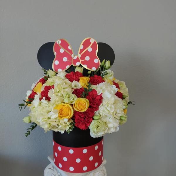 Mickey Mouse-themed flower arrangement in a polka-dot box