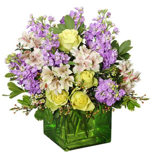 Bouquet of purple and white flowers in a green glass vase