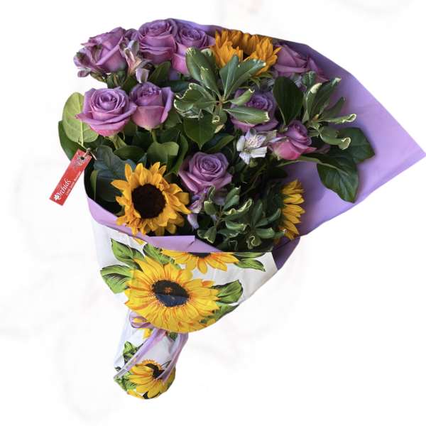 Bouquet of purple roses and yellow sunflowers wrapped in lavender paper
