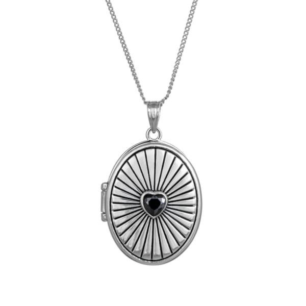 Silver locket necklace with a black heart center on a white background