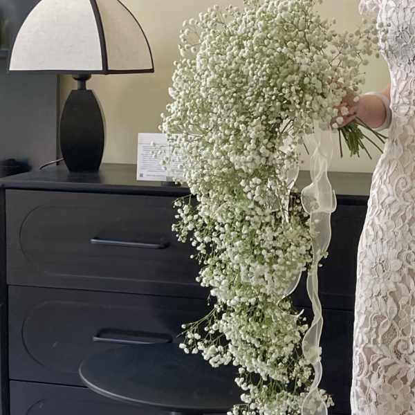 Large cascading bouquet of white baby's breath with a ribbon tie