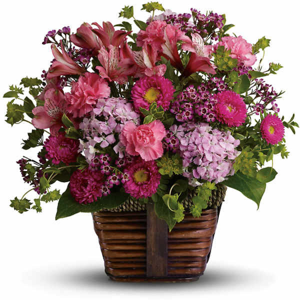 Pink mixed flower arrangement in a woven basket
