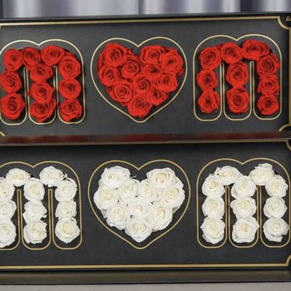 Two framed rose displays spelling MOM with a heart in the center.