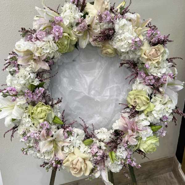 Heart-shaped floral wreath with white, blush, and lavender flowers