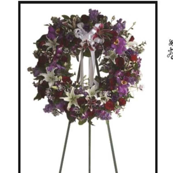 Purple and white floral wreath on a standing easel