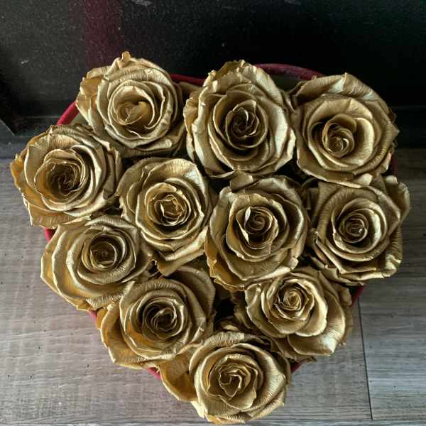 Heart-shaped box filled with gold roses