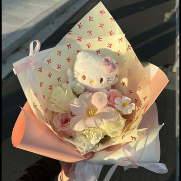 Hello Kitty plush in a pastel bouquet with pink and white flowers