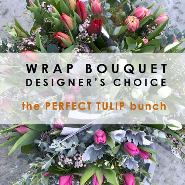 Wrapped bouquet of pink tulips with mixed greenery and small purple flowers