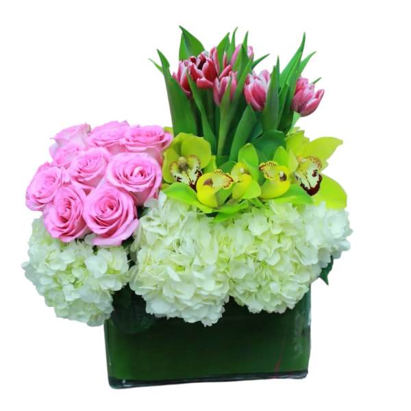 Pink roses, tulips, orchids, and white hydrangeas in a green vase