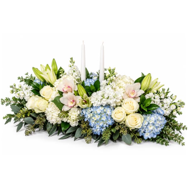 White floral centerpiece with candles and blue accents