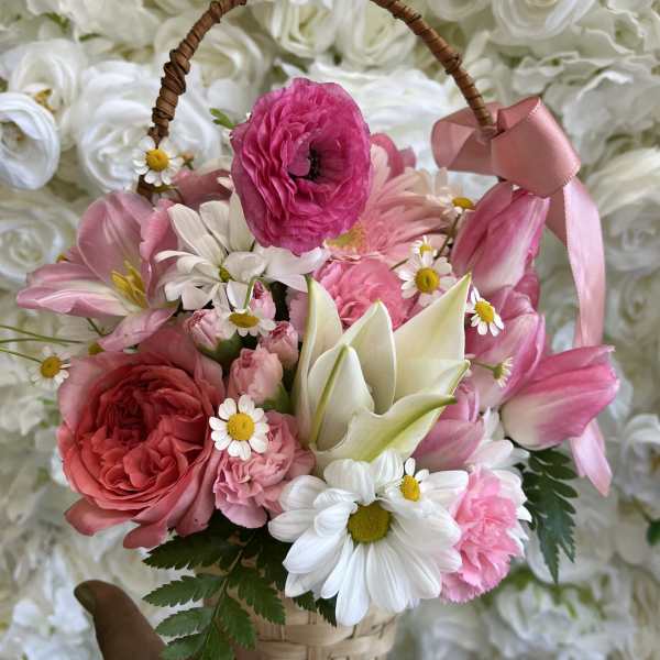 Pink and white flower basket with a ribbon handle