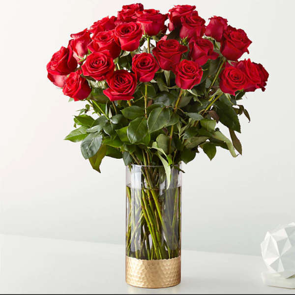 Bouquet of red roses in a tall clear vase