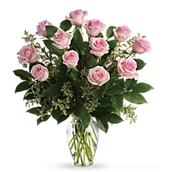 Pink roses arranged in a clear glass vase