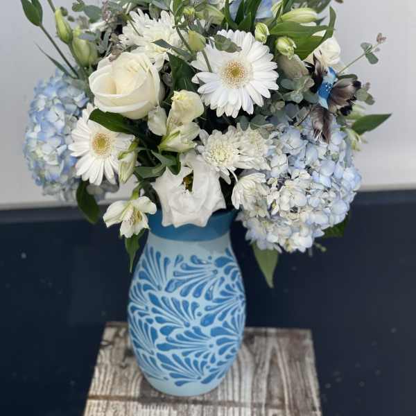 Blue and white floral arrangement in a patterned vase