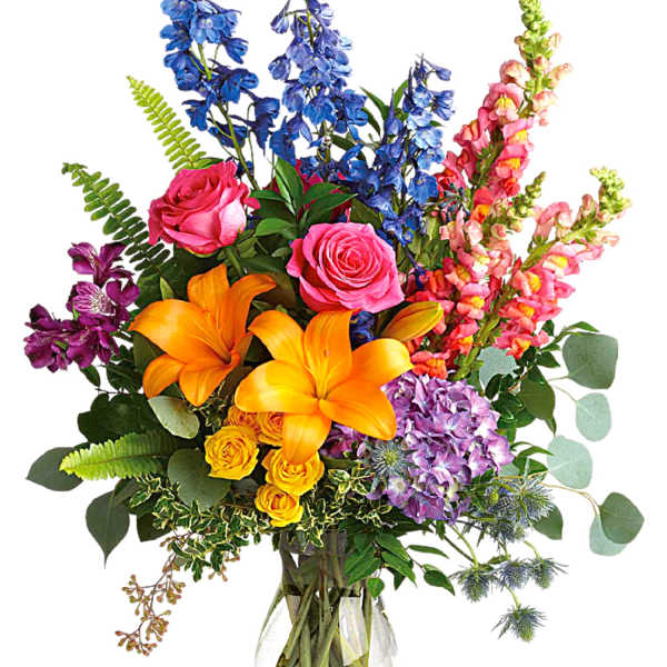 Colorful bouquet of roses, lilies, and snapdragons in a glass vase