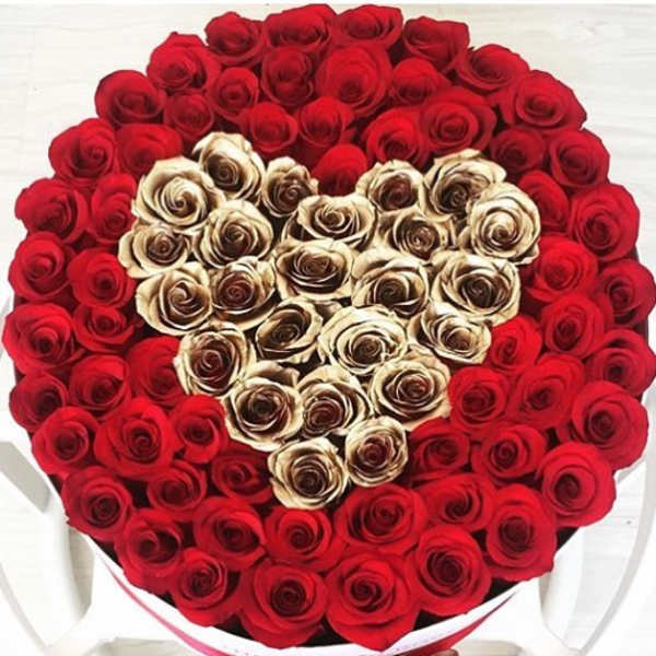 Heart-shaped bouquet of red and cream roses