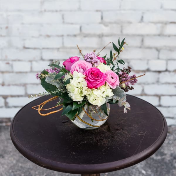 Pink and white rose bouquet in a clear glass vase