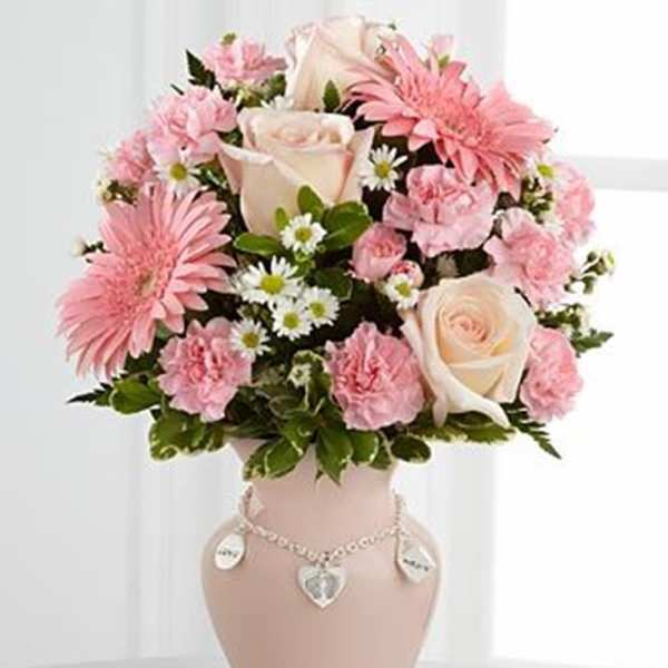Pink and white flower arrangement in a decorative vase