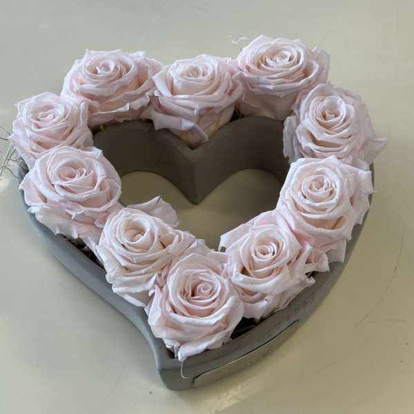 Heart-shaped box filled with pale pink roses