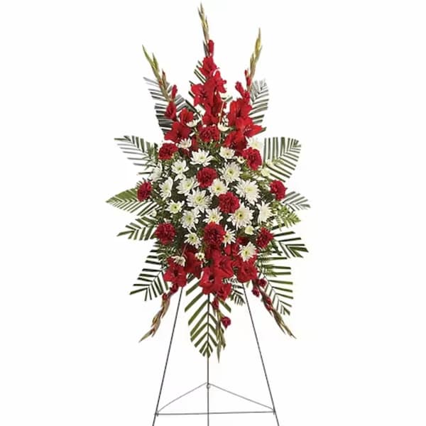 Standing floral spray with red and white flowers on an easel