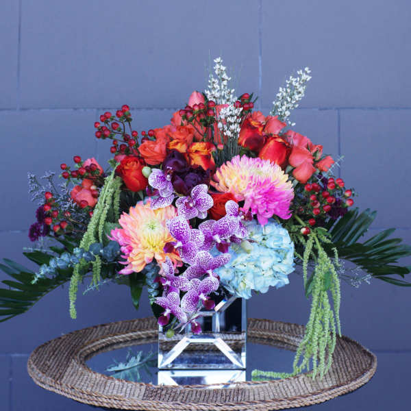 Colorful mixed bouquet in a clear cube vase