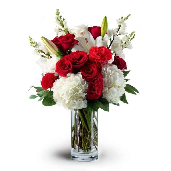 Red roses and white lilies in a clear glass vase