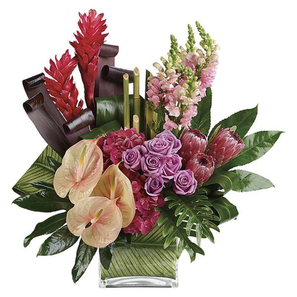 Tropical bouquet with pink roses, anthuriums, and red ginger in a glass vase