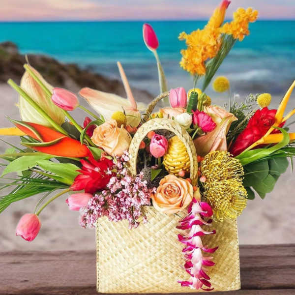 Tropical flower arrangement in a woven basket with pink and orange blooms