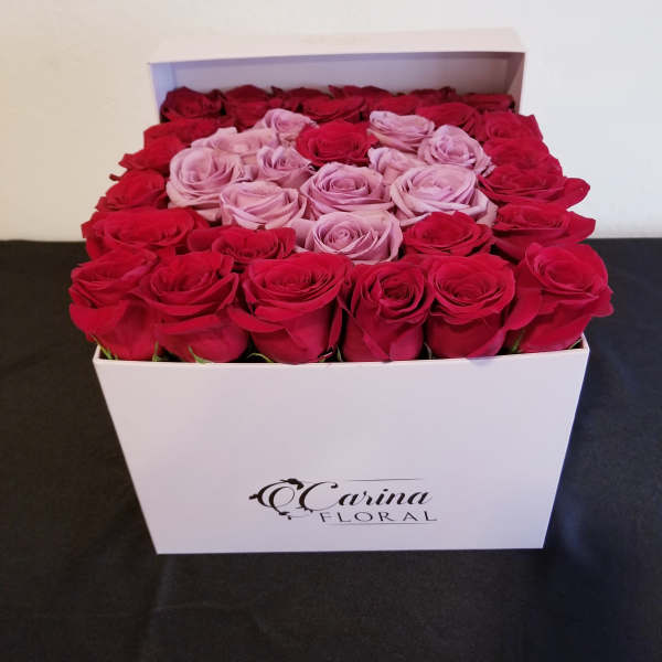 Box of red and pink roses arranged in a white gift box