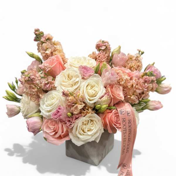 Pink and white rose bouquet in a gray box with a ribbon