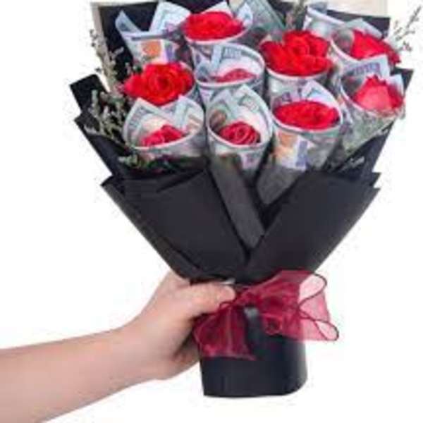 Bouquet of red roses wrapped in black paper with a red ribbon