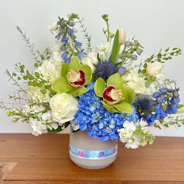Blue and white floral arrangement in a gray vase