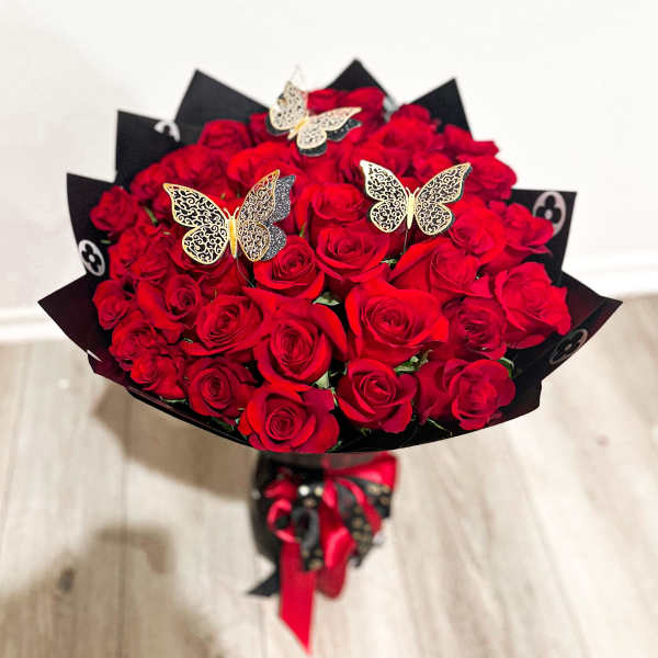 Bouquet of red roses with butterfly picks and black wrapping