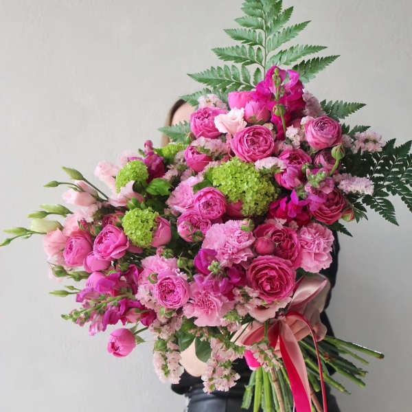 Large pink bouquet with roses and carnations tied with ribbon