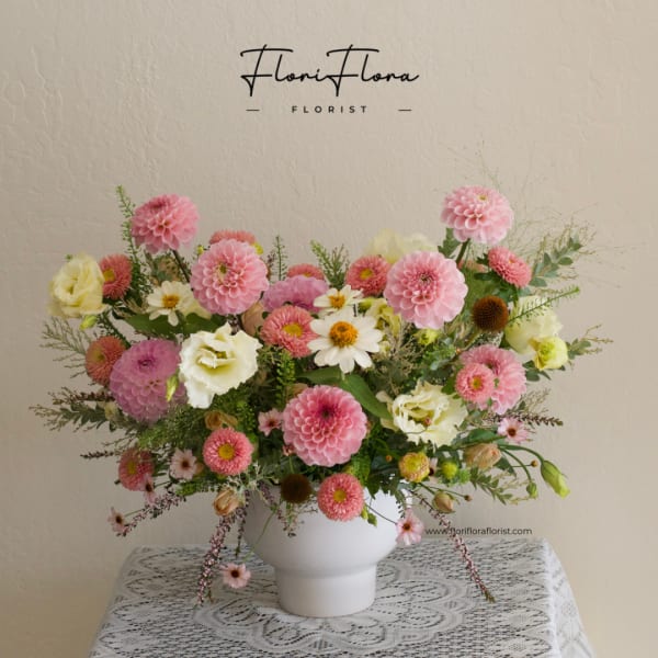 Pink and white mixed flower arrangement in a white vase