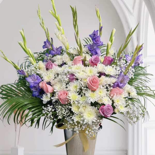Tall bouquet of pink and white flowers in a vase