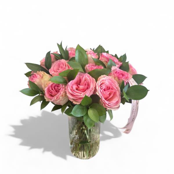 Pink roses arranged in a clear glass vase