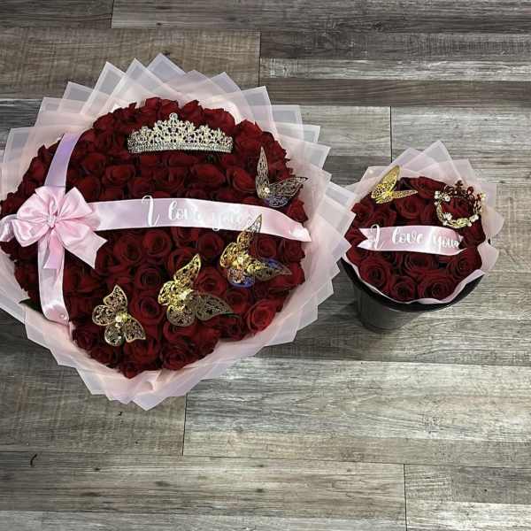 Two red rose bouquets with pink ribbon, tiaras, and butterfly decorations