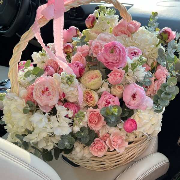 Pink and white flower basket with a ribbon handle
