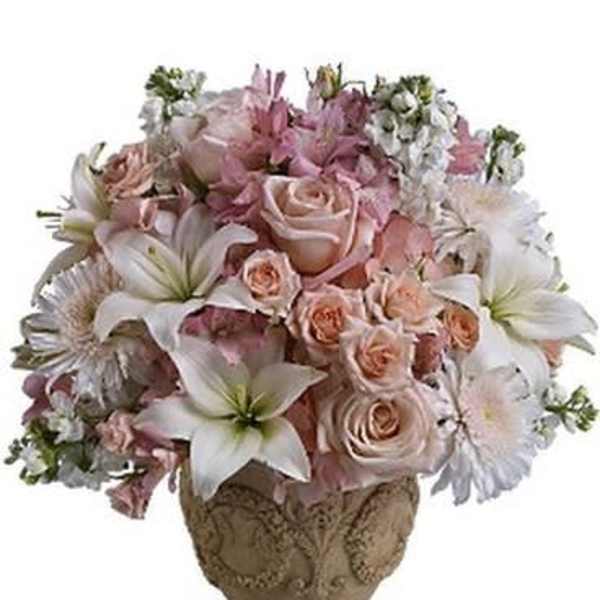 Pink and white floral arrangement in a decorative vase