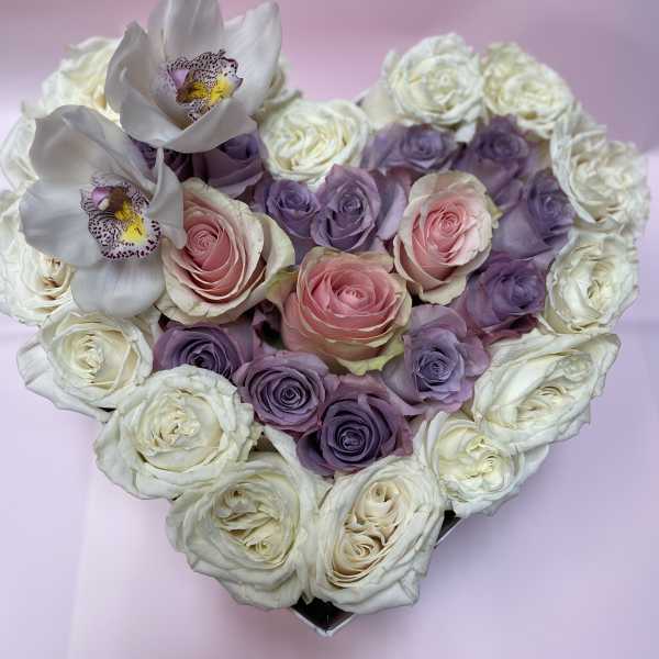 Heart-shaped bouquet of pink, purple, and white roses with white orchids