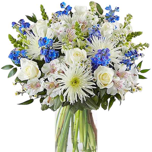 White and blue mixed bouquet in a clear glass vase