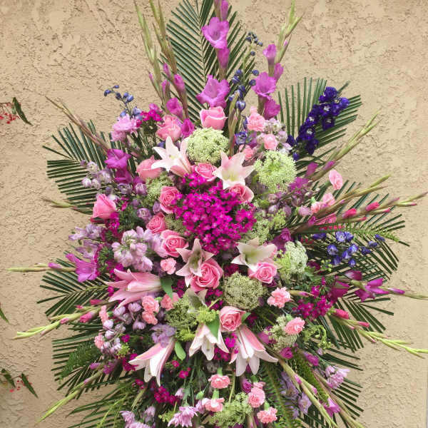 Large pink and purple floral spray with lilies and roses