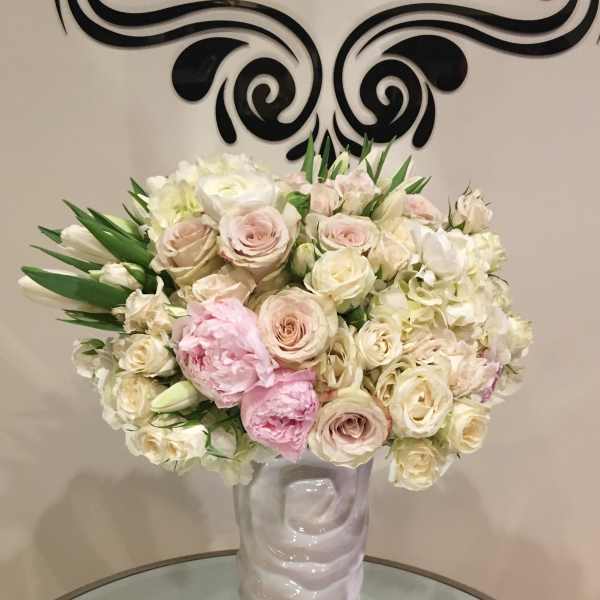 Blush and white rose bouquet in a tall white vase
