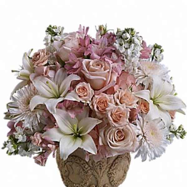 Pink and white floral arrangement in an ornate vase