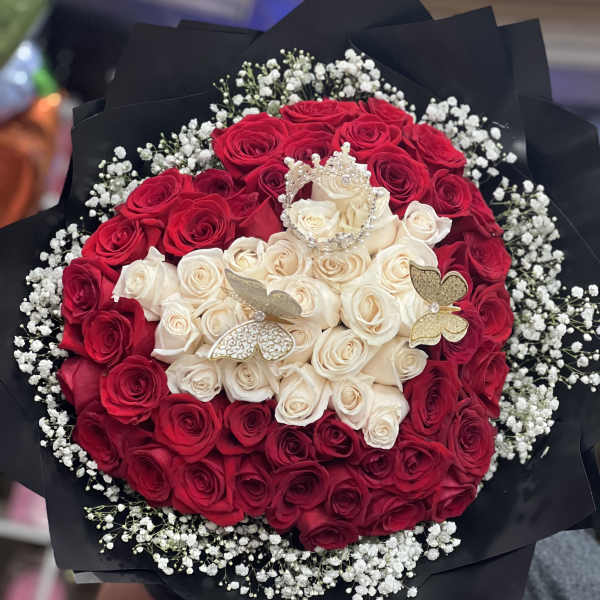 Bouquet of red and white roses with baby’s breath in black wrap